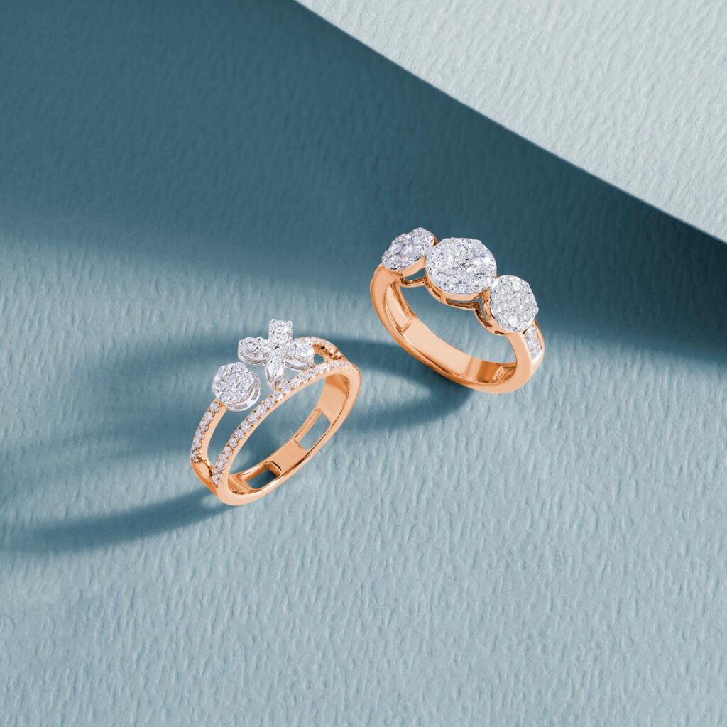 Close-up of luxurious diamond rings on a textured blue surface, showcasing elegance and craftsmanship.