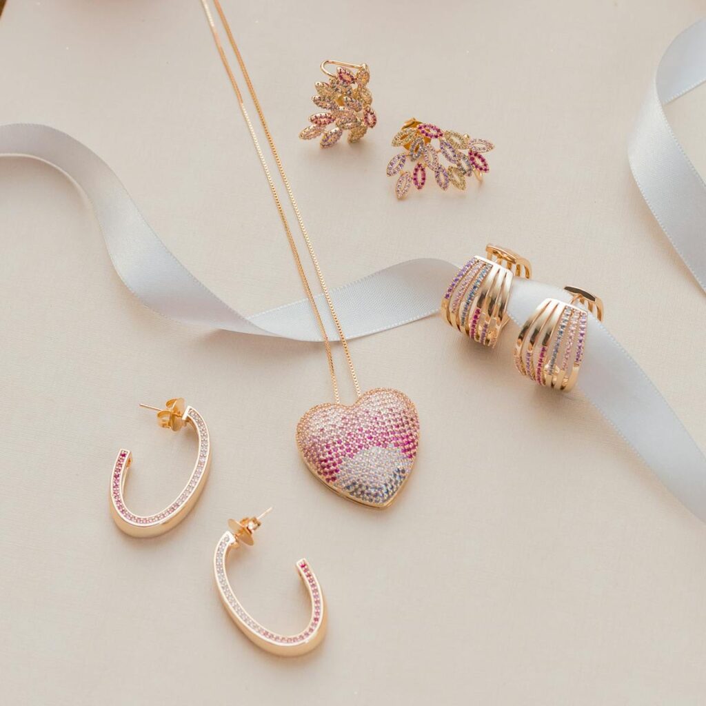 Elegant jewelry arrangement featuring heart pendant and earrings on light background.